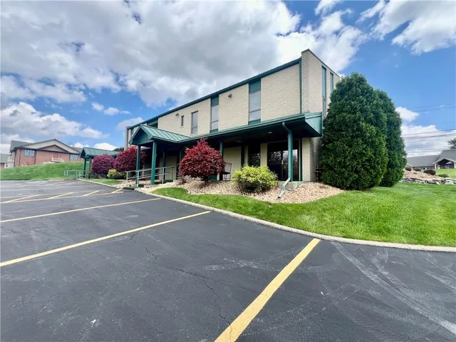 a view of a house with a yard and plants