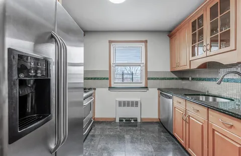 a kitchen with stainless steel appliances granite countertop a refrigerator and a sink