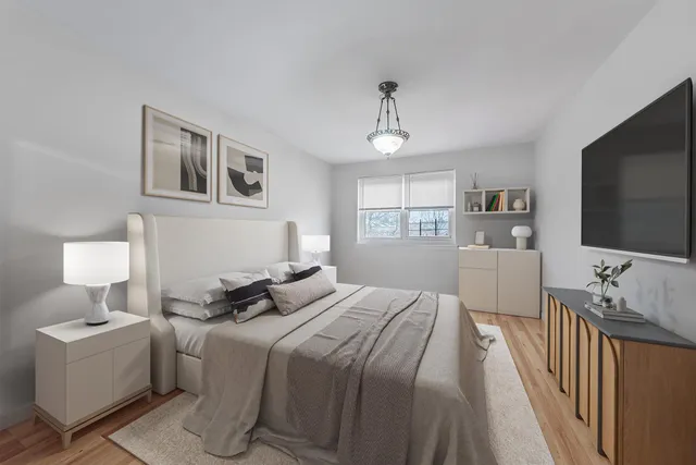 a bedroom with a bed and a flat screen tv