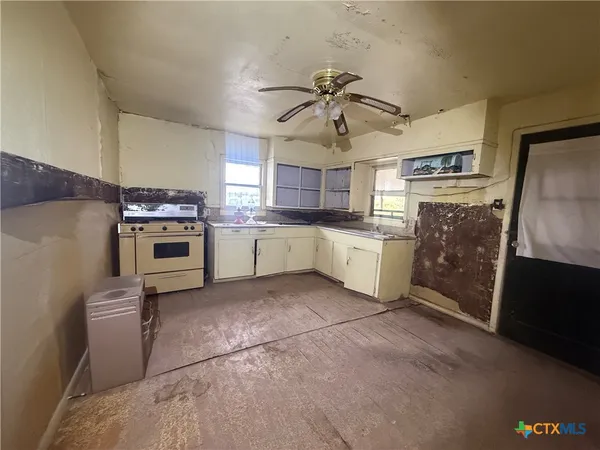 a kitchen with a stove and a microwave