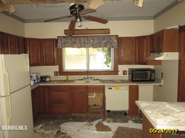 415 Bowen Street Savanna, IL 61074 - Photo 8 of 19 a kitchen with a stove a refrigerator and a sink