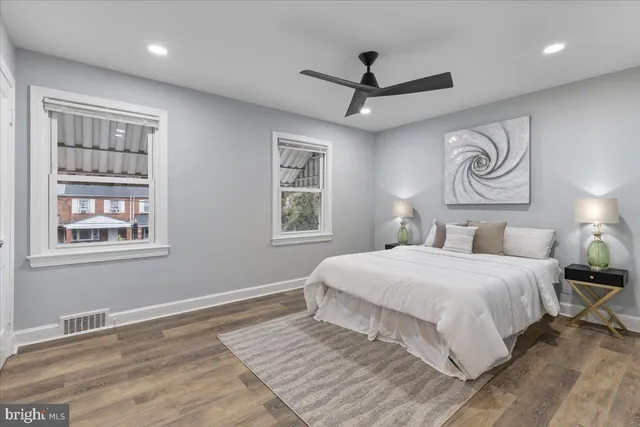 a bedroom with a large bed and a chandelier