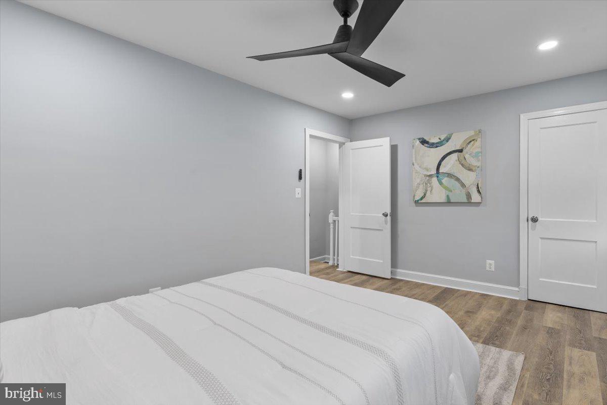 2202 U Place Southeast Washington, DC 20020 - Photo 15 of 21 a bedroom with a large bed and a chandelier