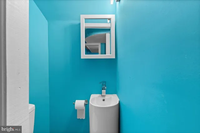 a bathroom with a sink and a washer dryer