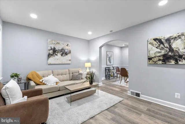 a living room with furniture and wooden floor