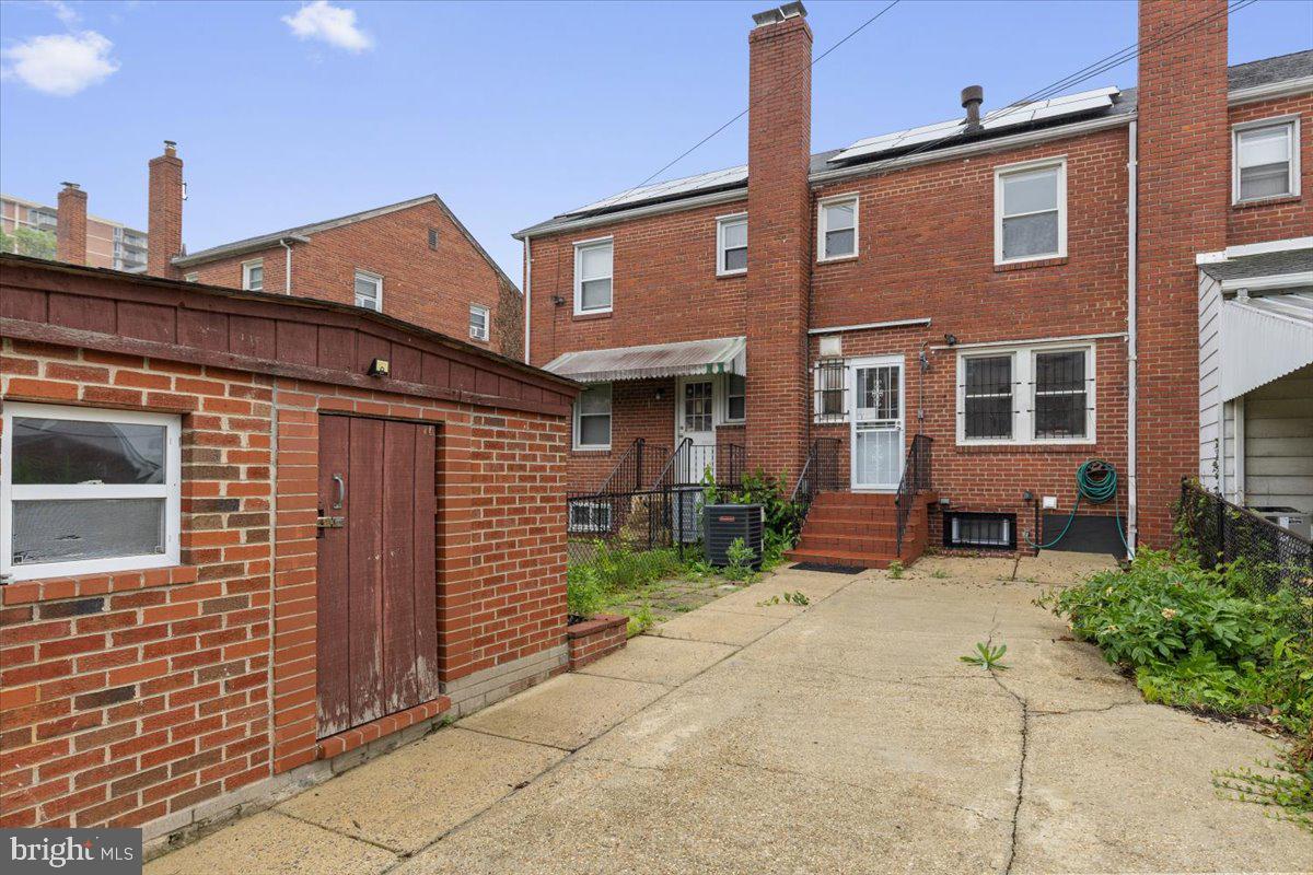 2202 U Place Southeast Washington, DC 20020 - Photo 21 of 21 a view of a brick house with plants and large tree