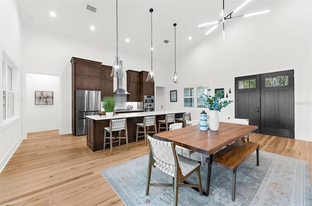1044 Riverside Ridge Road Tarpon Springs, FL 34688 - Photo 11 of 77 a kitchen with stainless steel appliances kitchen island granite countertop a table chairs and a refrigerator