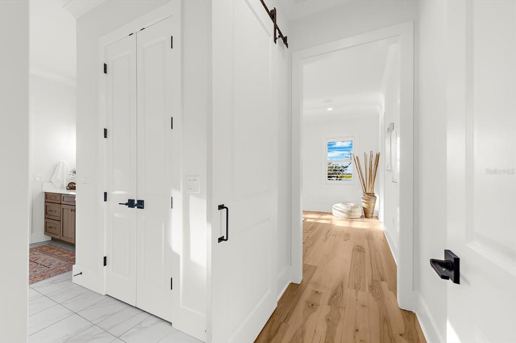 1044 Riverside Ridge Road Tarpon Springs, FL 34688 - Photo 34 of 77 a view of a hallway with wooden floor and staircase