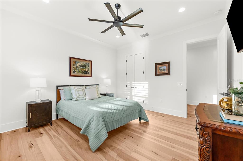 1044 Riverside Ridge Road Tarpon Springs, FL 34688 - Photo 39 of 77 a bedroom with a bed and a table in it