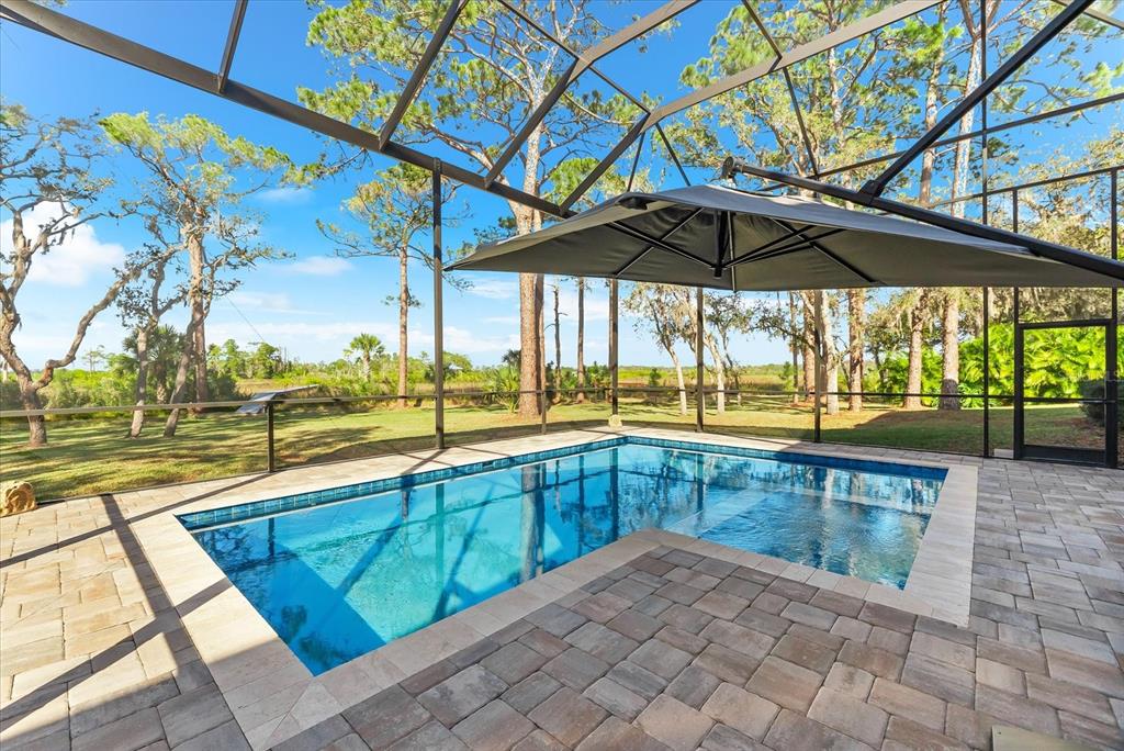 1044 Riverside Ridge Road Tarpon Springs, FL 34688 - Photo 52 of 77 a view of a swimming pool with a porch