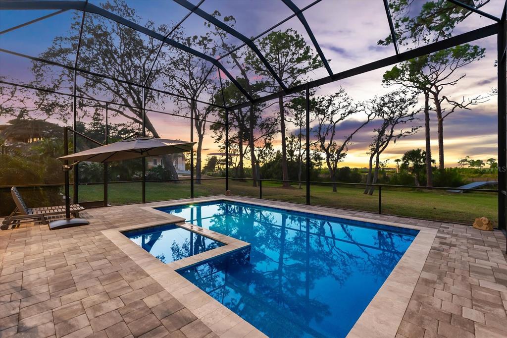 1044 Riverside Ridge Road Tarpon Springs, FL 34688 - Photo 64 of 77 a swimming pool with outdoor seating and patio