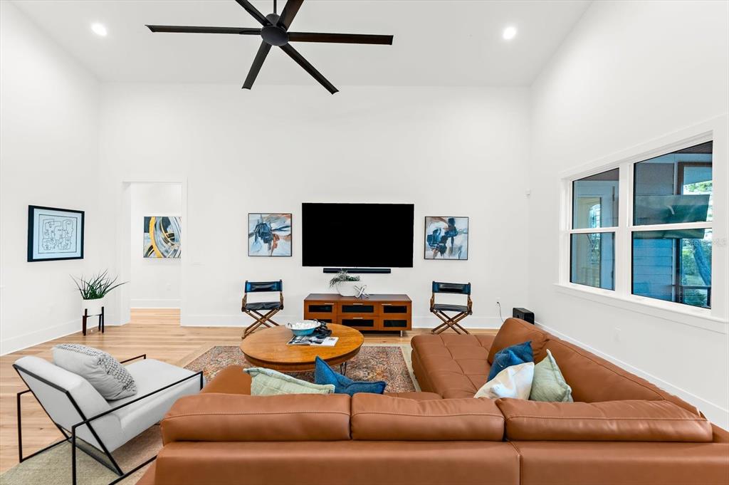 1044 Riverside Ridge Road Tarpon Springs, FL 34688 - Photo 10 of 77 a living room with furniture and a flat screen tv