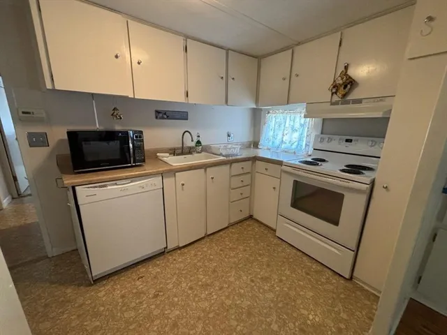 a kitchen with cabinets appliances and a sink