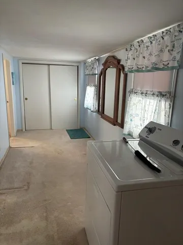 a bedroom with a bed window and tub