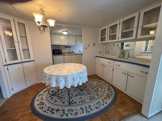 a view of a kitchen with granite countertop a sink dining table and chairs