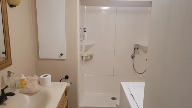 a bathroom with a bath tub with a shower