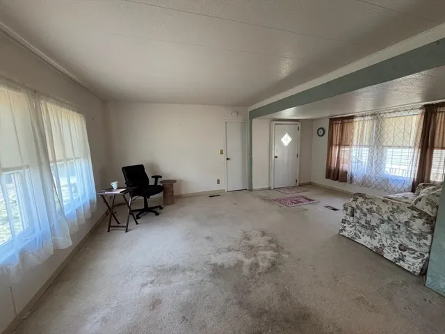 a view of a livingroom with furniture and a window