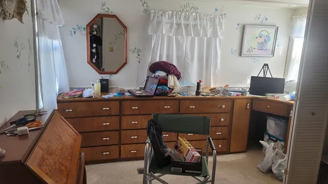 a room with a mirror and a dresser