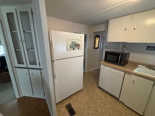 a utility room with wooden floor washer and dryer