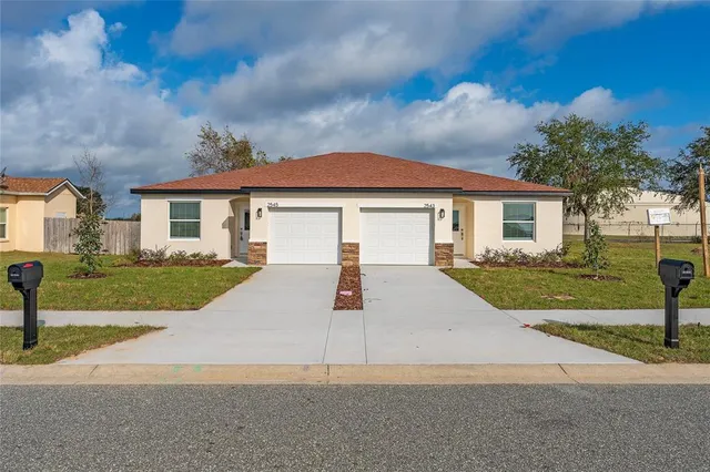 a view of house with yard and street