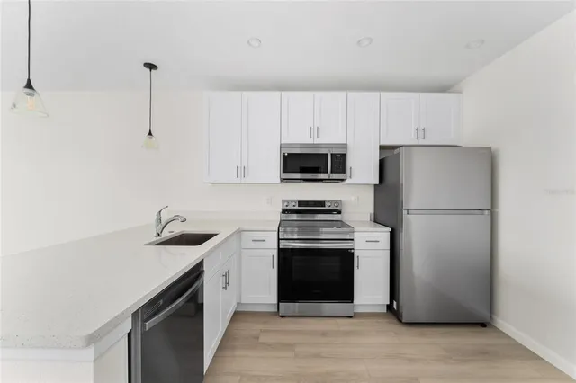 a kitchen with a refrigerator sink and stove