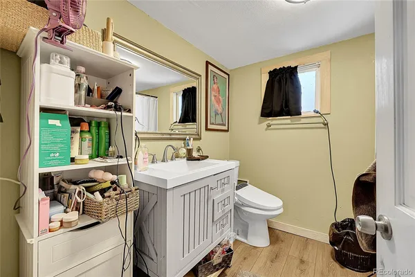 a bathroom with a sink a toilet and a window
