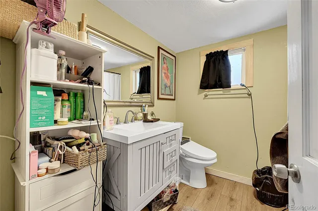 a bathroom with a sink a toilet and a window