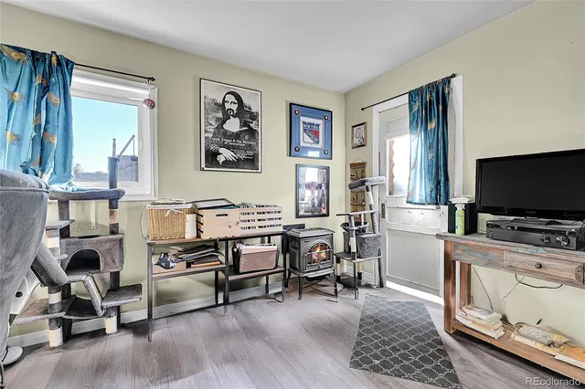 a view of a livingroom with workspace and a window