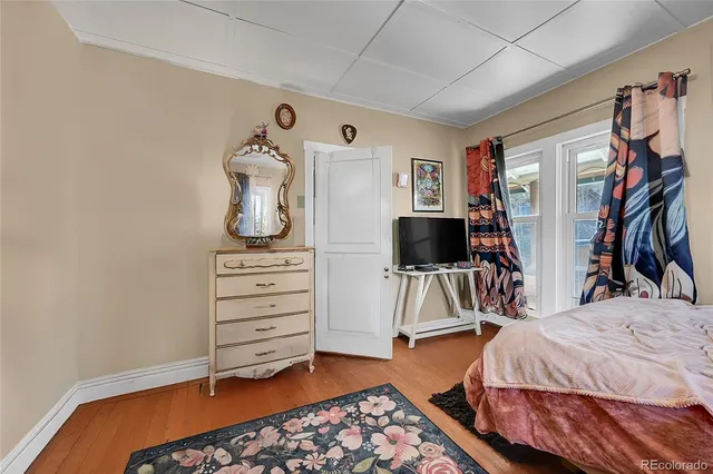 a bedroom with a bed and a flat tv screen