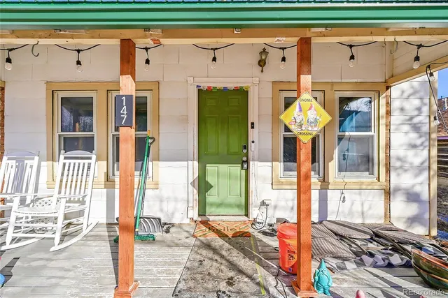 a front view of a house with a garden and plants