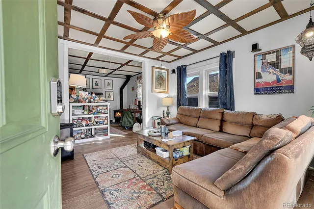 a living room with furniture a rug and a chandelier