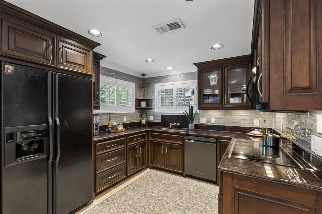 1306 Morrow Road Valley View, TX 76272 - Photo 32 of 40 a kitchen with granite countertop a sink stainless steel appliances and cabinets