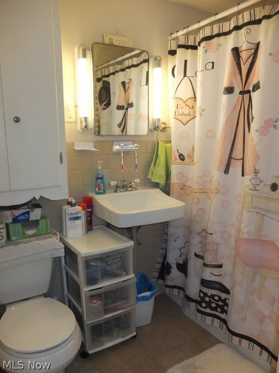 2437 11th Street Northwest Canton, OH 44708 - Photo 12 of 18 Downstairs Unit: Full bath has new tile floor, sink, toilet and lighting.