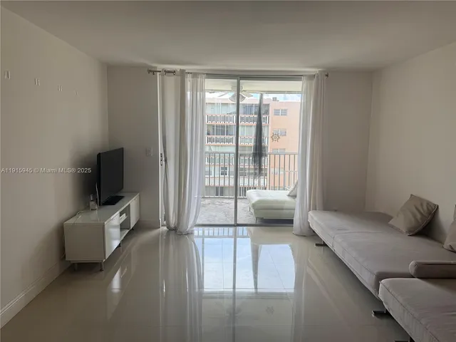 a bedroom with furniture and flat screen tv