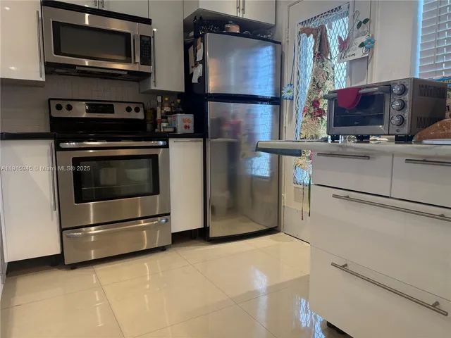 a kitchen with stainless steel appliances and cabinets