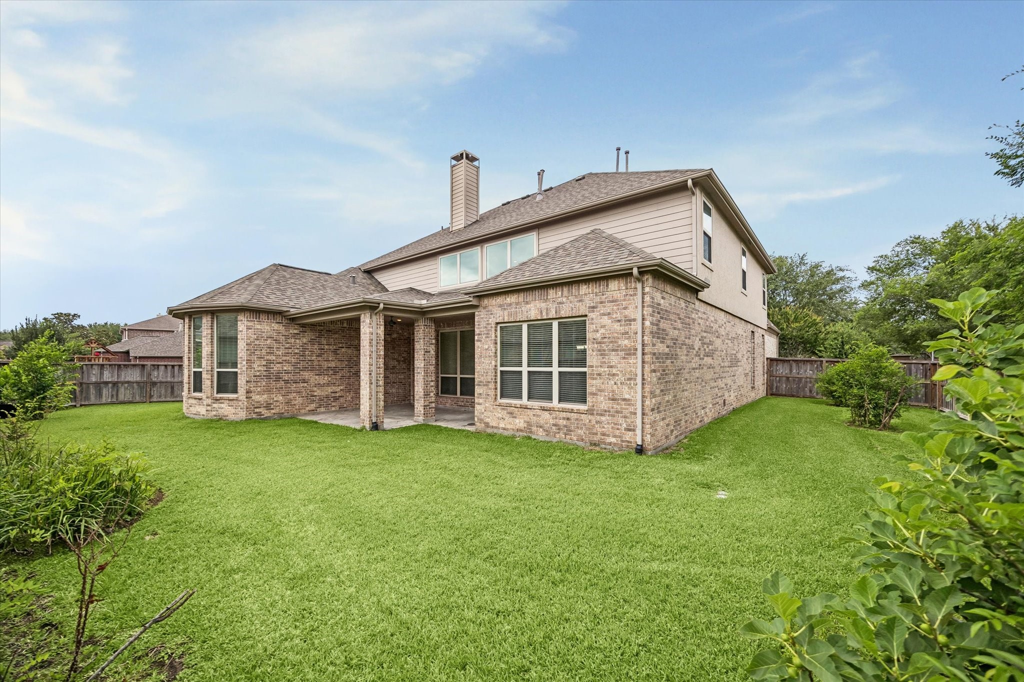 17403 Astrachan Road Richmond, TX 77407 - Photo 31 of 40 The yard is spacious and well-maintained, featuring a lush green lawn, covered patio and a wooden fence for privacy.
