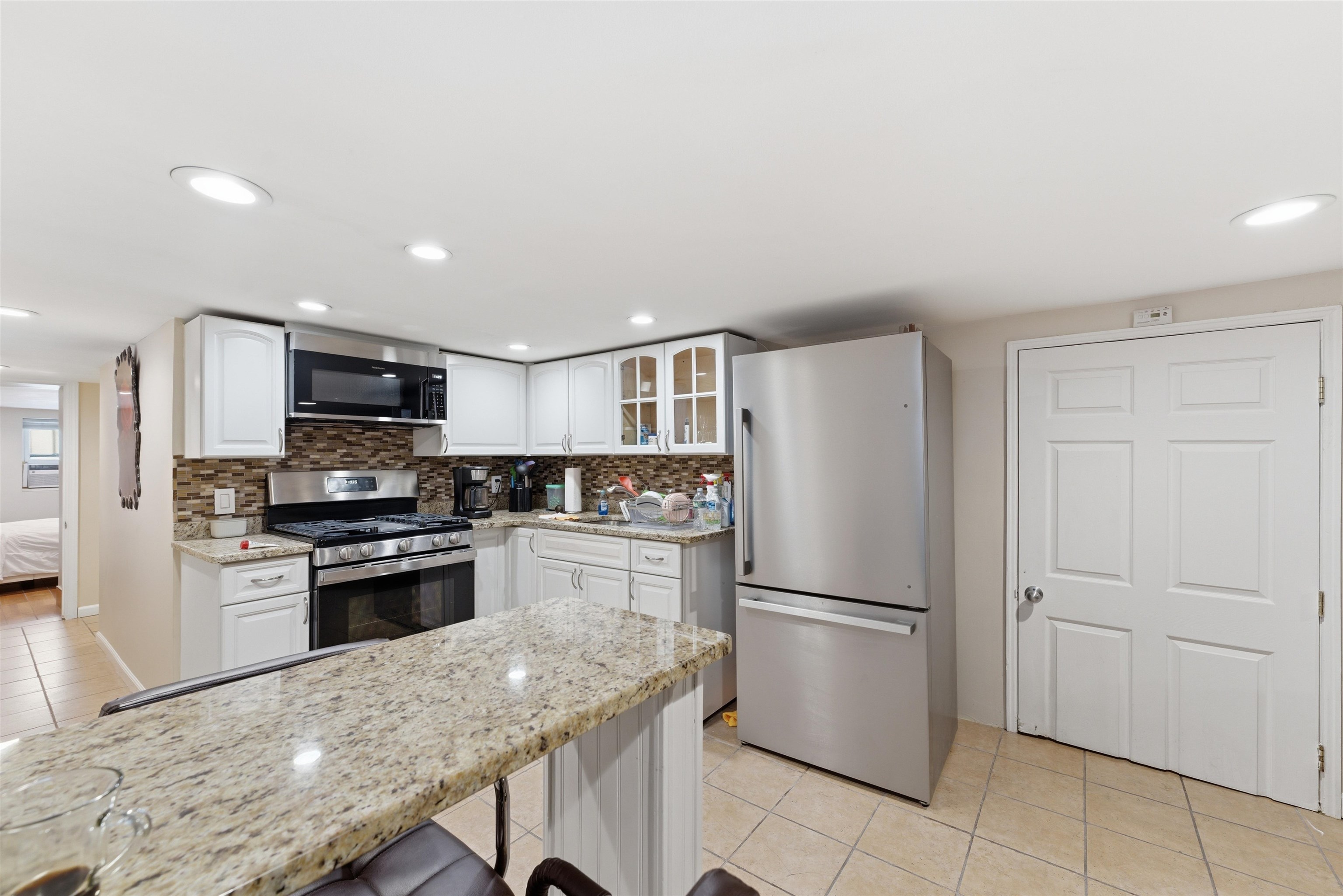 921 Paterson Plank Road North Bergen, NJ 07047 - Photo 11 of 50 a kitchen with stainless steel appliances granite countertop a refrigerator stove and oven