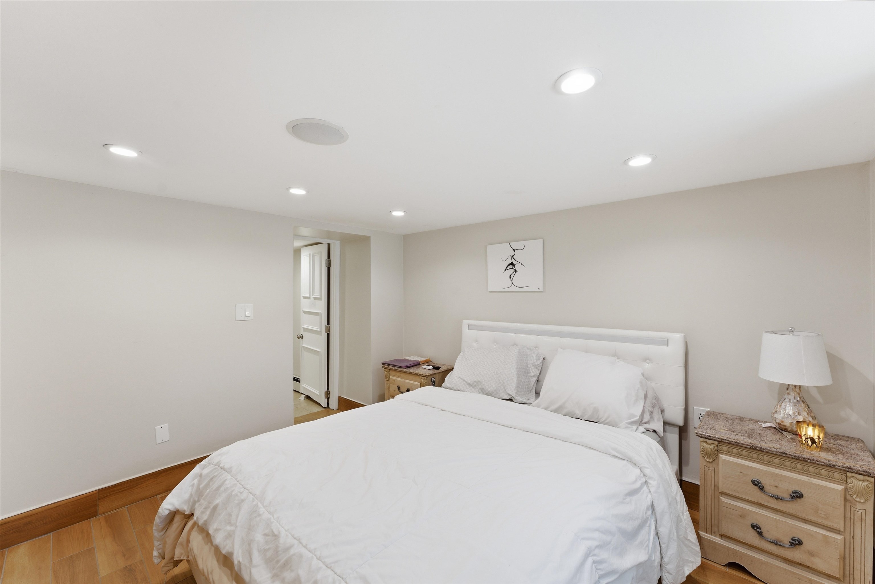 921 Paterson Plank Road North Bergen, NJ 07047 - Photo 12 of 50 a bedroom with a bed and a lamp