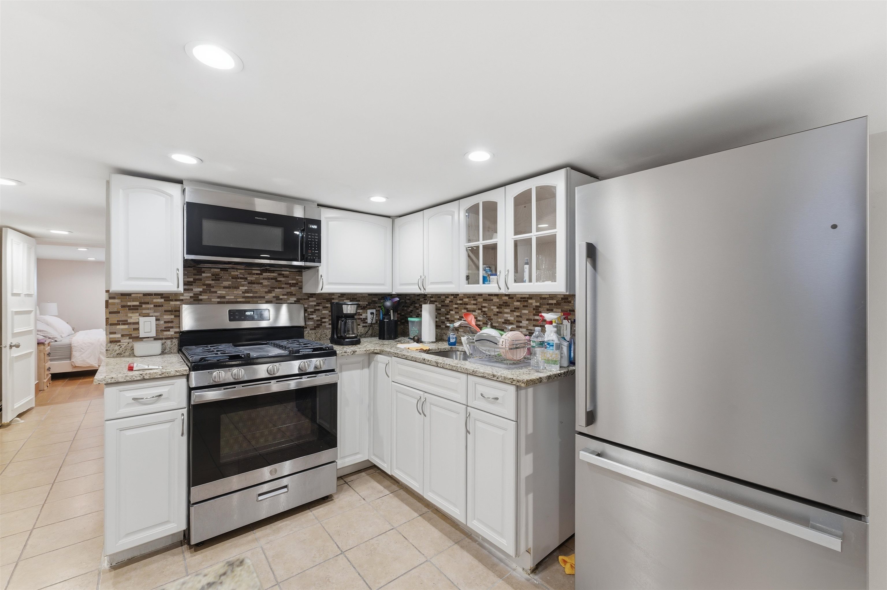 921 Paterson Plank Road North Bergen, NJ 07047 - Photo 19 of 50 a kitchen with stainless steel appliances a stove sink and microwave