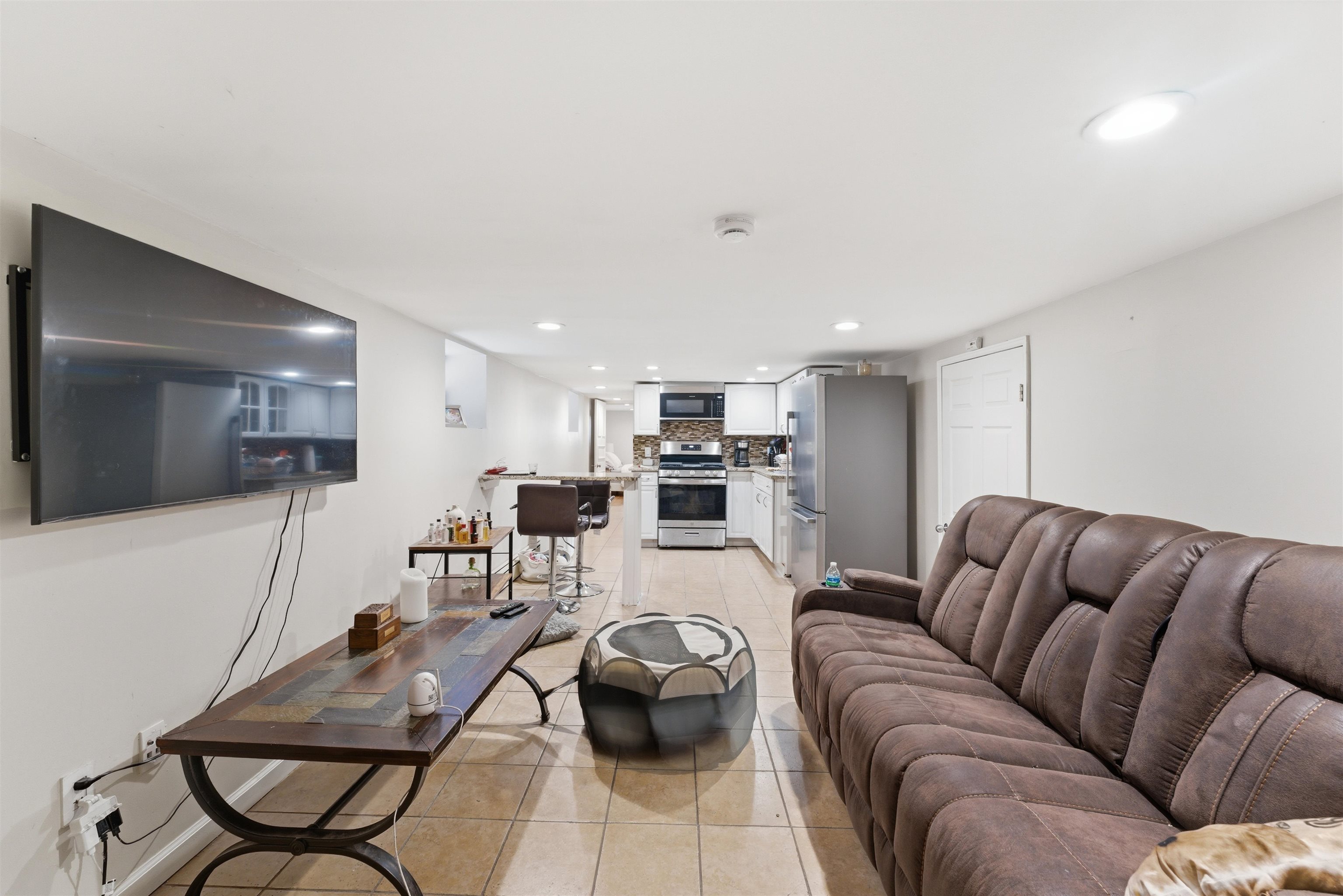 921 Paterson Plank Road North Bergen, NJ 07047 - Photo 21 of 50 a living room with furniture and a flat screen tv