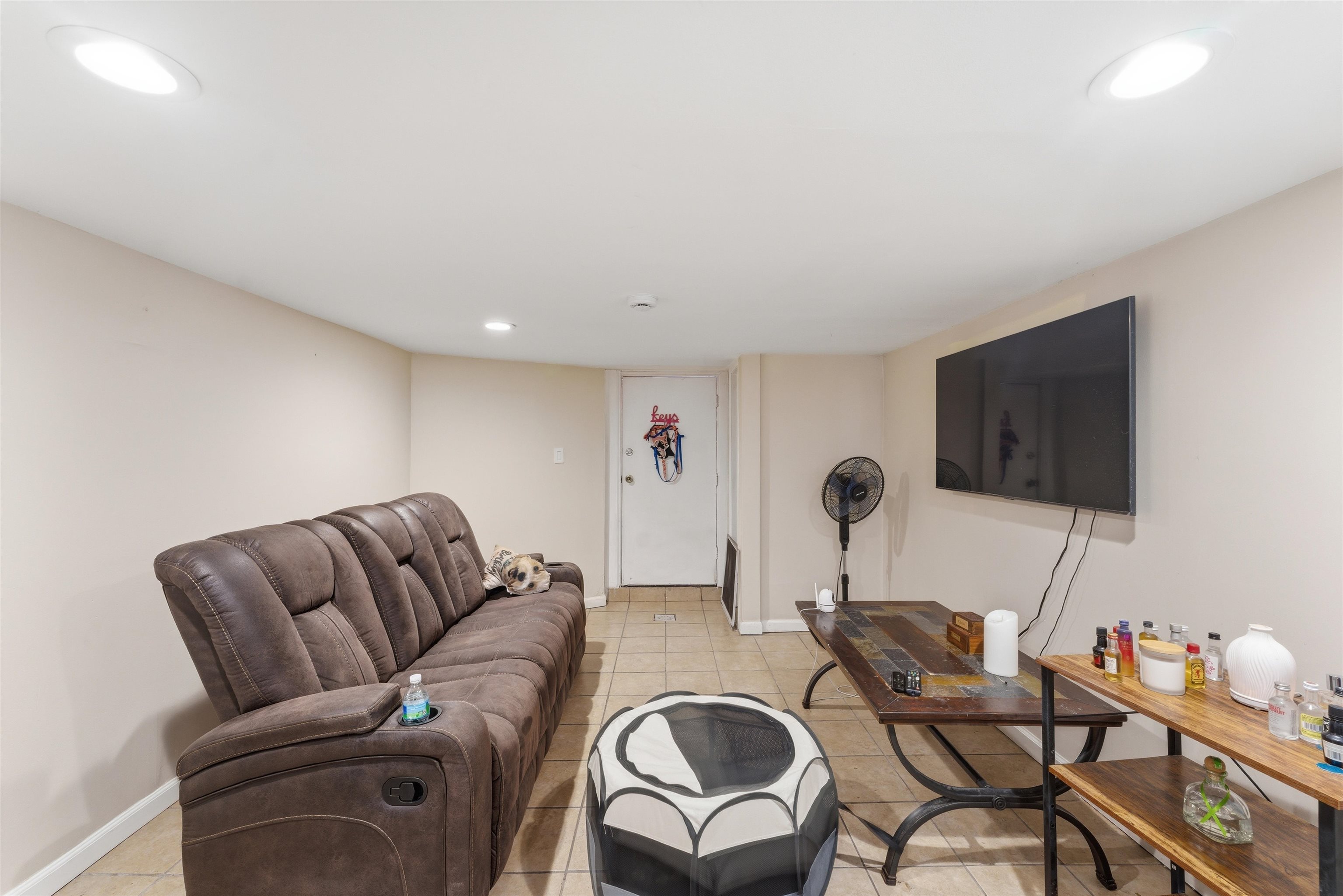 921 Paterson Plank Road North Bergen, NJ 07047 - Photo 22 of 50 a living room with furniture and a flat screen tv