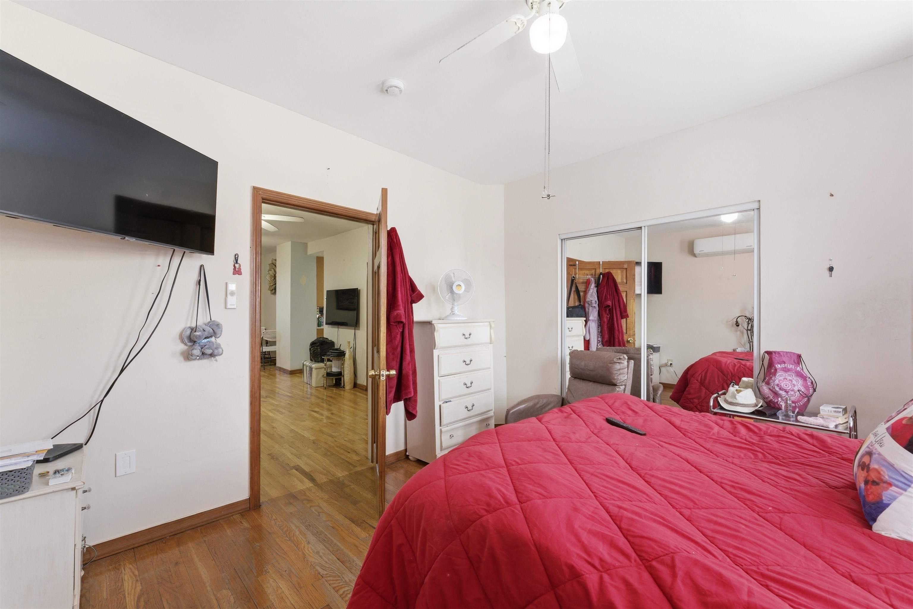 921 Paterson Plank Road North Bergen, NJ 07047 - Photo 23 of 50 a bedroom with a bed and a flat tv screen on wall