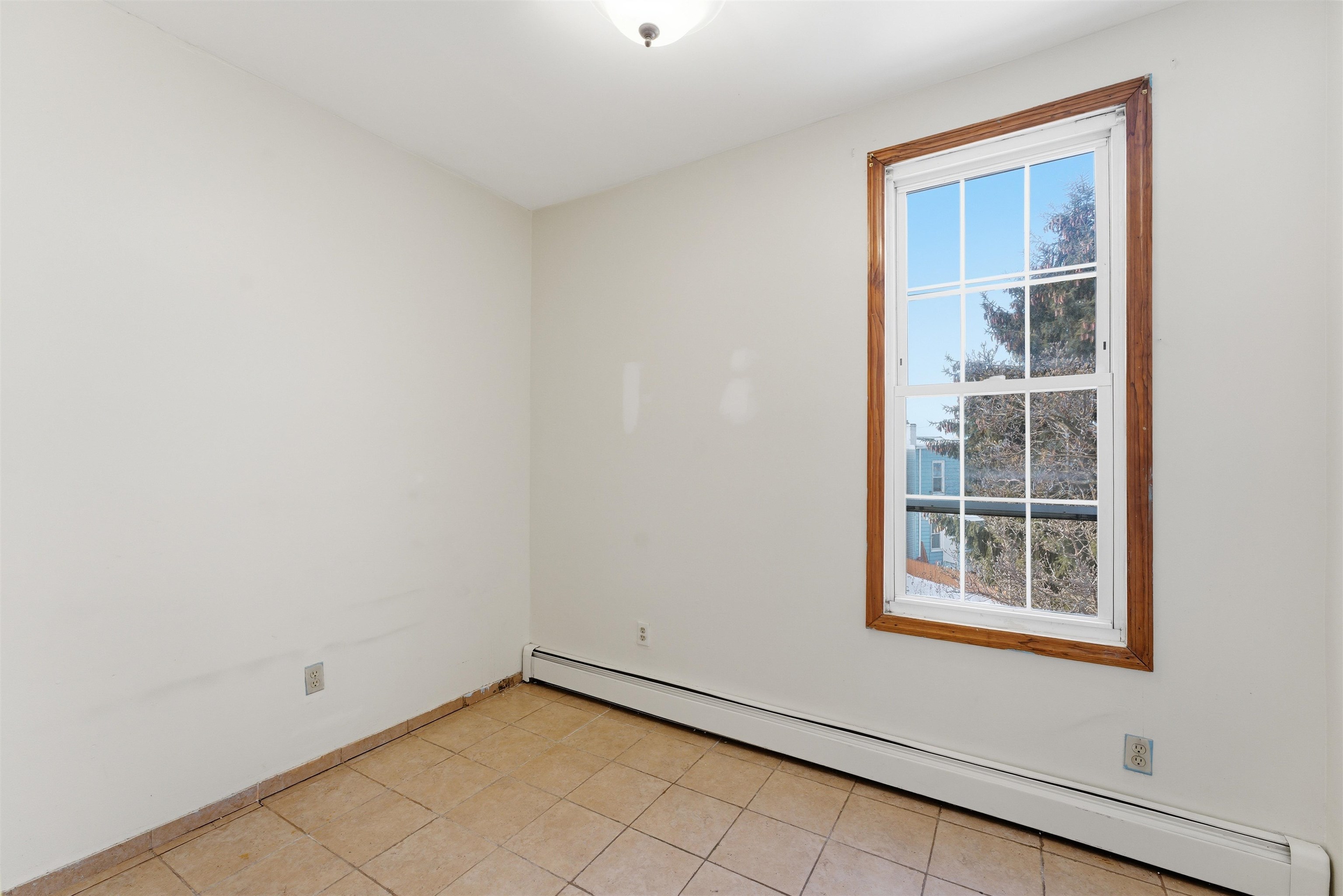 921 Paterson Plank Road North Bergen, NJ 07047 - Photo 3 of 50 a view of an empty room with a window