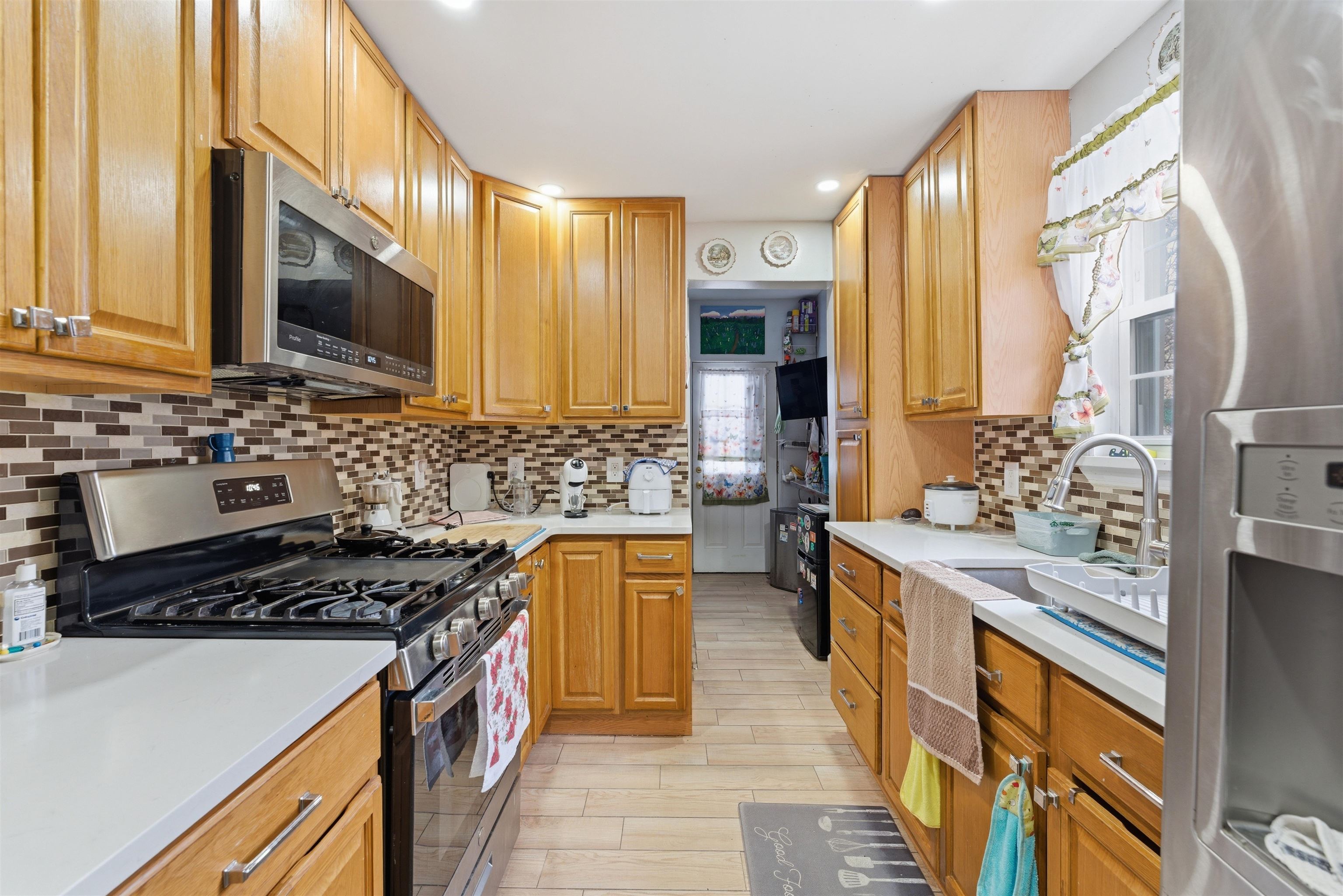 921 Paterson Plank Road North Bergen, NJ 07047 - Photo 33 of 50 a kitchen with stainless steel appliances a stove sink and cabinets