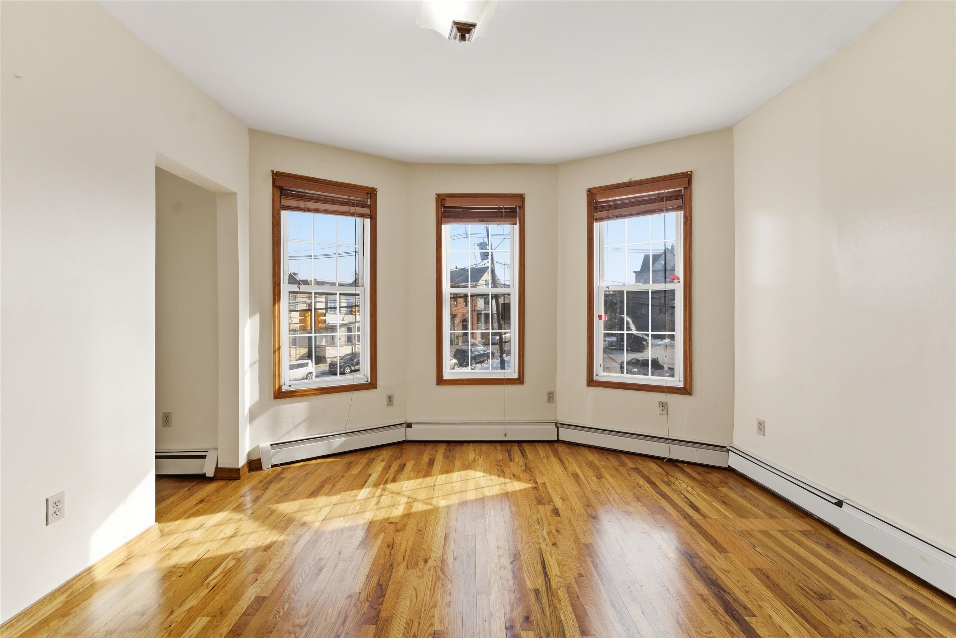 921 Paterson Plank Road North Bergen, NJ 07047 - Photo 42 of 50 a view of empty room with wooden floor and fan