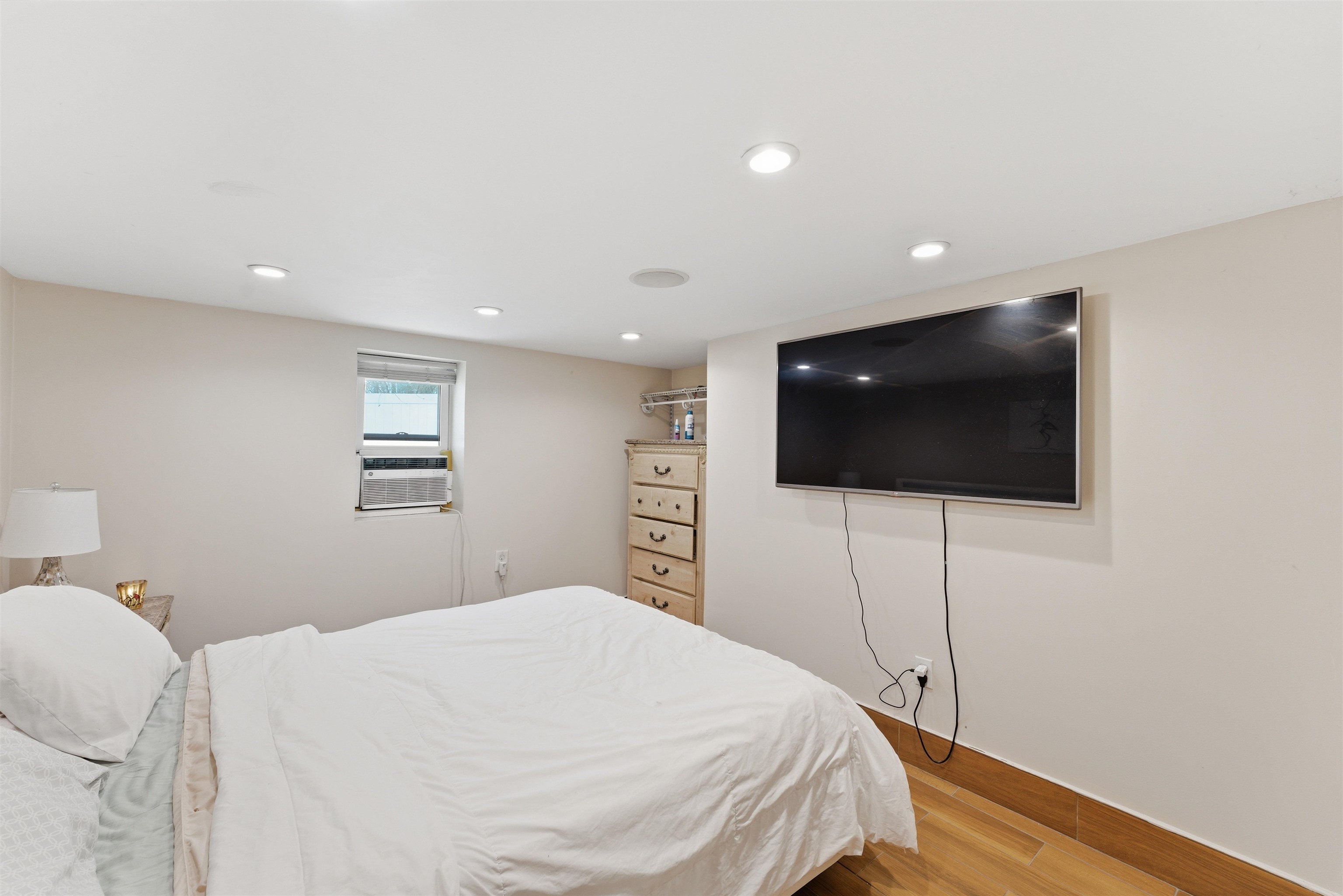 921 Paterson Plank Road North Bergen, NJ 07047 - Photo 43 of 50 a bedroom with a bed and a flat screen tv