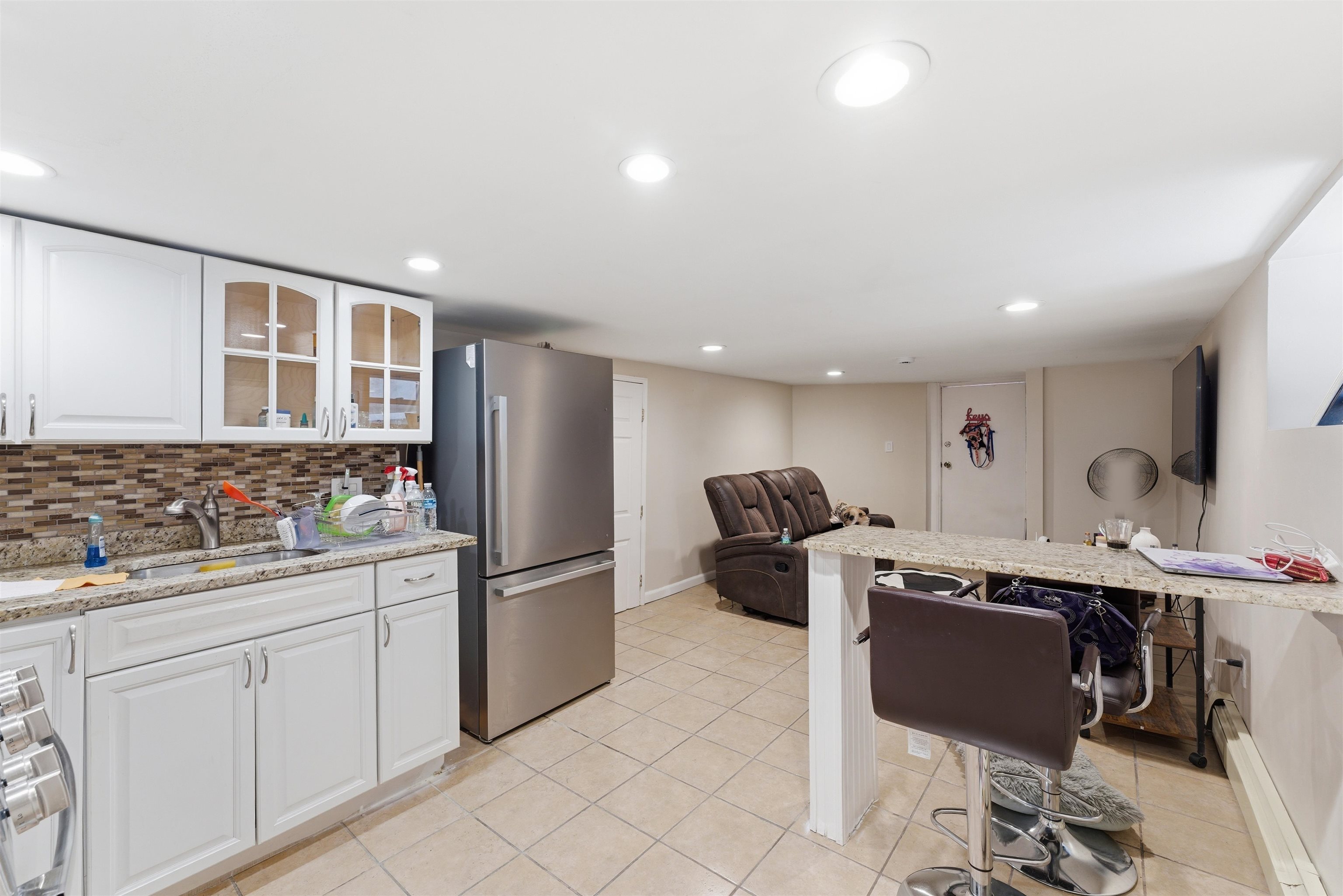 921 Paterson Plank Road North Bergen, NJ 07047 - Photo 45 of 50 a kitchen with stainless steel appliances kitchen island granite countertop a sink and cabinets