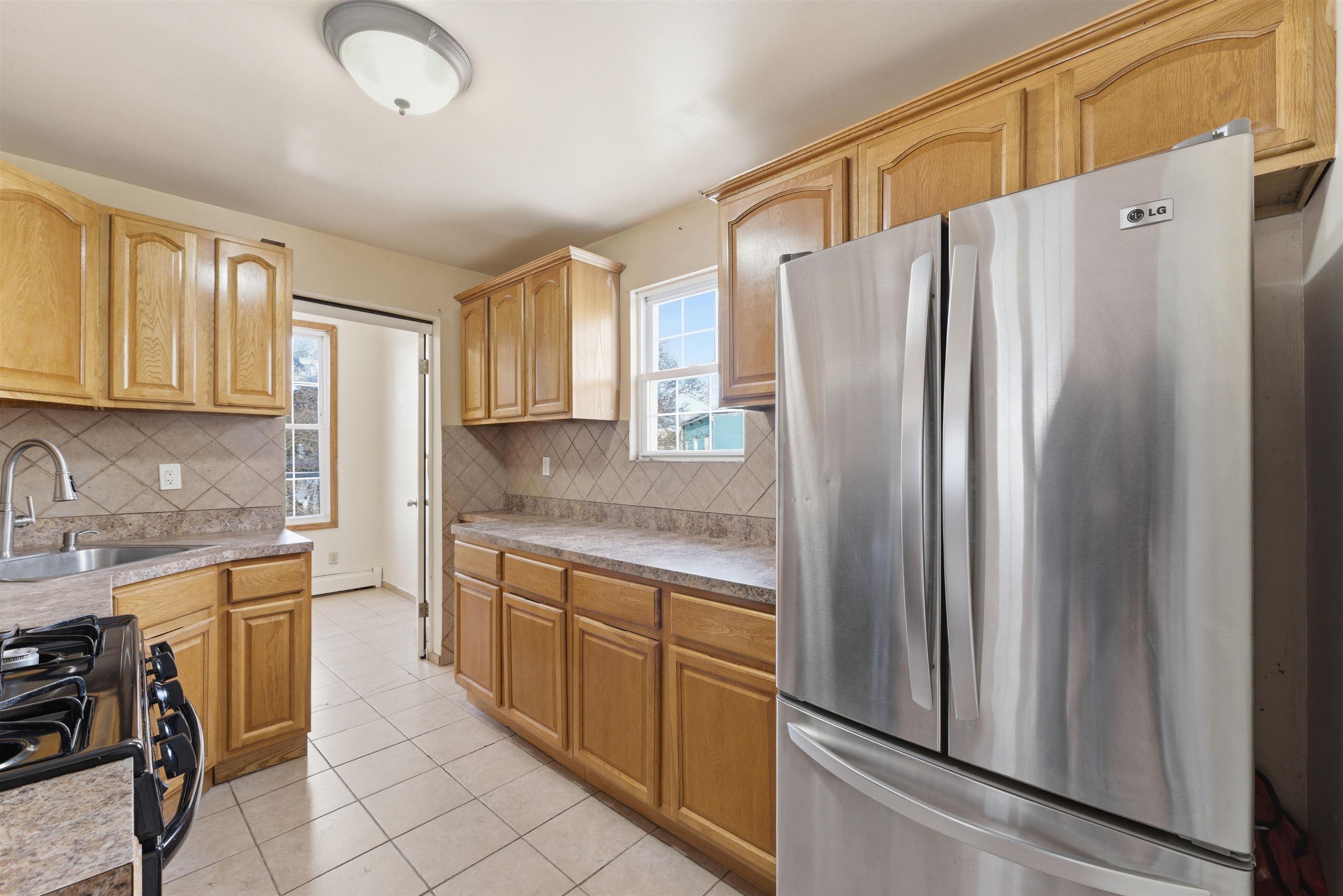 921 Paterson Plank Road North Bergen, NJ 07047 - Photo 5 of 50 a kitchen with granite countertop a refrigerator and a sink