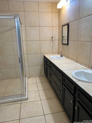 a bathroom with a granite countertop sink a toilet and a mirror