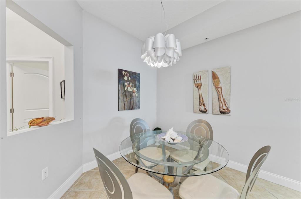 611 Riviera Dunes Way, Unit 304 Palmetto, FL 34221 - Photo 11 of 30 a dining room with furniture and wooden floor